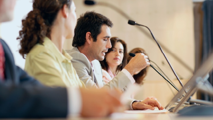 Panel of people at micrphones