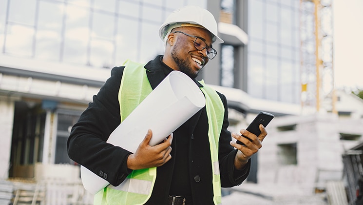 Worker with blueprints in business conversation