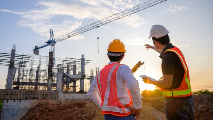 Construction workers looking at crane